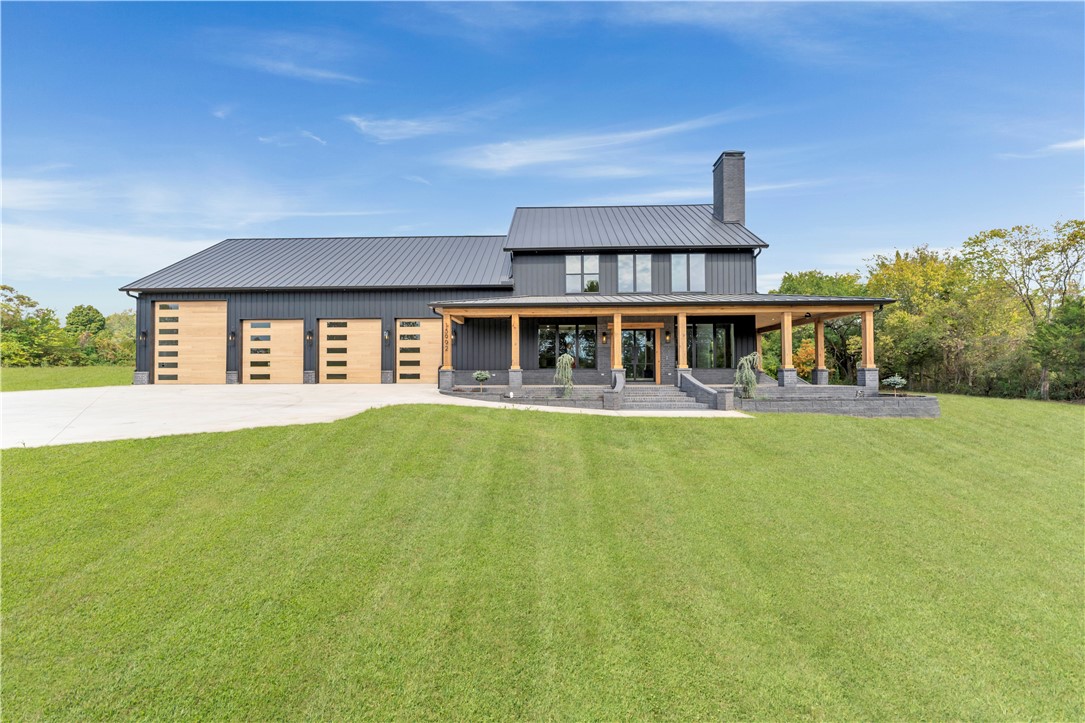 Luxurious Bardominium on one acre, with 1,100 of wrap around covered porch with casing ceiling, 10x10 cedar post, porch swing to enjoy you morning coffee, 40x50 attached shop with RV access, beautiful large modern entry door, chef style kitchen with Cafe Style Kitchen appliances, 8 burner range with pot filler and custom build range hood, includes refrigerator, large kitchen island, hidden pantry with beverage fridge and wine storage, soft closing cabinets and drawers, wood burning brick fireplace, high ceilings with beams, metal stair railing, all luxury vinyl plank flooring, 2 living areas, spacious bedroom with walk-in closets, tiled wall shower in main bathroom includes rain shower head, body sprayers, shower wand and shower bench, central vacuum, ring doorbell, professional landscaping with self-watering gardens from Rain Bird.