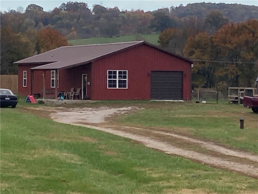 Like New 2023 built Bardominium setting on 1.5+/- acres. This 2 bedroom, 2 full bath home has custom finishes, fixtures, and touches throughout, including a bonus room that has many possibilities, 3rd bedroom or nursery etc...... The open floor plan with tall ceilings makes the spacious living area great for family get togethers. . Luxury Vinyl, stained concrete, and ceramic tile make floor cleaning a breeze. Come home and relax in the whirlpool tub or enjoy a sunset from the hot tub on the back porch. Pet friendly fenced back yard is perfect for your furry friends. This house has structural spray foam throughout, which makes it very energy efficient and the metal exterior means low maintenance. Plenty of room to grow your own garden and have a few farm animals also. Like new storage building can convey with the right offer. Located just north of HWY 412 makes it an easy commute to Huntsville/Springdale to the West or Harrison/Branson to the East and Berryville/Green Forest is just a short drive to the North.