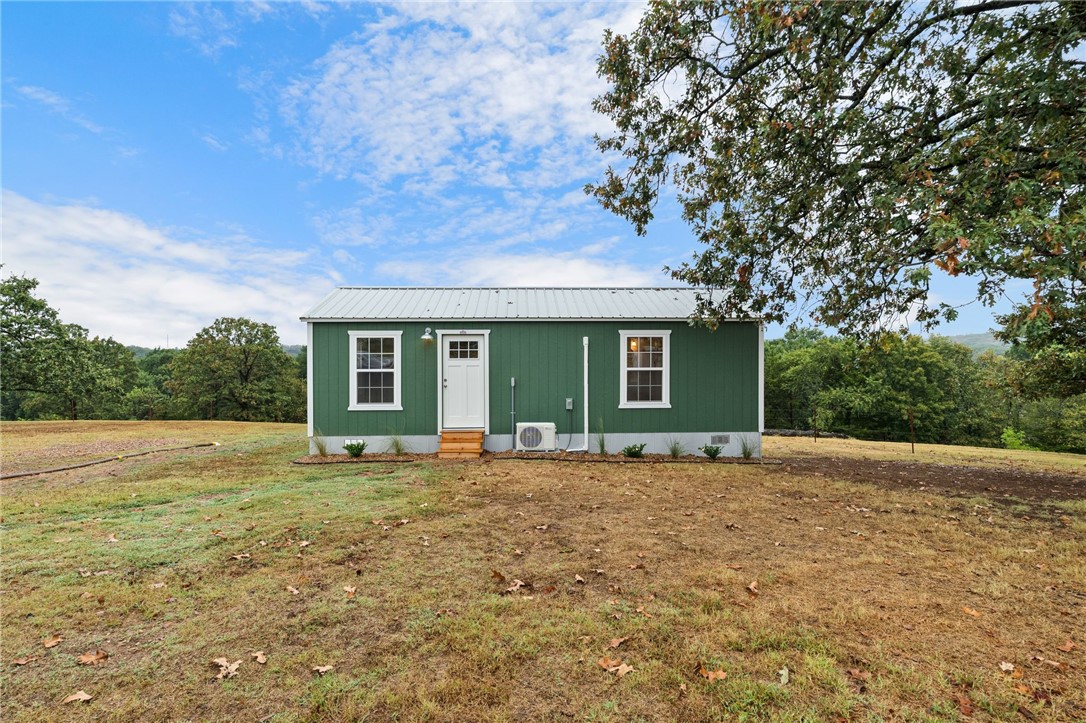 Discover this unique 6-acre property just minutes from Booneville Lake and a short drive to Greenwood, Ft. Smith, and Mt. Magazine State Park. The centerpiece is a new 448 sq ft studio cabin on concrete piers with luxury vinyl plank flooring, Samsung SmartThings range, Rheem water heater, and mini-split HVAC for year-round comfort. Enjoy sunrise and sunset views from the deck in a peaceful, unrestricted setting—ideal for homesteading, a weekend getaway, or an Airbnb. Property includes a 33 ft RV pad with full hookups plus two septic systems: one for the cabin and a new 4BD system for future builds. Fiber optic internet, public water, and electric service are in place. Abundant wildlife, blackberries, valley and hilltop views add to the appeal. Whether you want to downsize, invest, or build, this property offers endless potential. Seller open to conventionally financed offers.