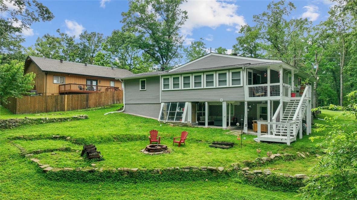 This spacious 4 bedroom, 3 bathroom home offers the perfect blend of comfort and convenience. Enjoy the large dining room, ideal for gatherings and a chef style kitchen with a huge pantry. The bright sunroom on the main level offers a peaceful retreat with loads of natural light and scenic views of the woods. The primary suite has an updated en suite bathroom and expansive walk-in closet. The walkout basement, complete with its own entrance, presents endless possibilities- an in-law suite, AirBnB or extra living space. Don't miss the flex room not counted in the bedrooms perfect for an office, home gym or even playroom. Have lots of stuff? This home has tons of storage! Step outside to your private oasis with an outdoor kitchen, gardener's greenhouse and fire pit perfect for entertaining. Just steps from the Lago Vista Bike trail and down the street from Lake Avalon, you'll enjoy easy access to all the outdoor recreation Bella Vista has to offer.