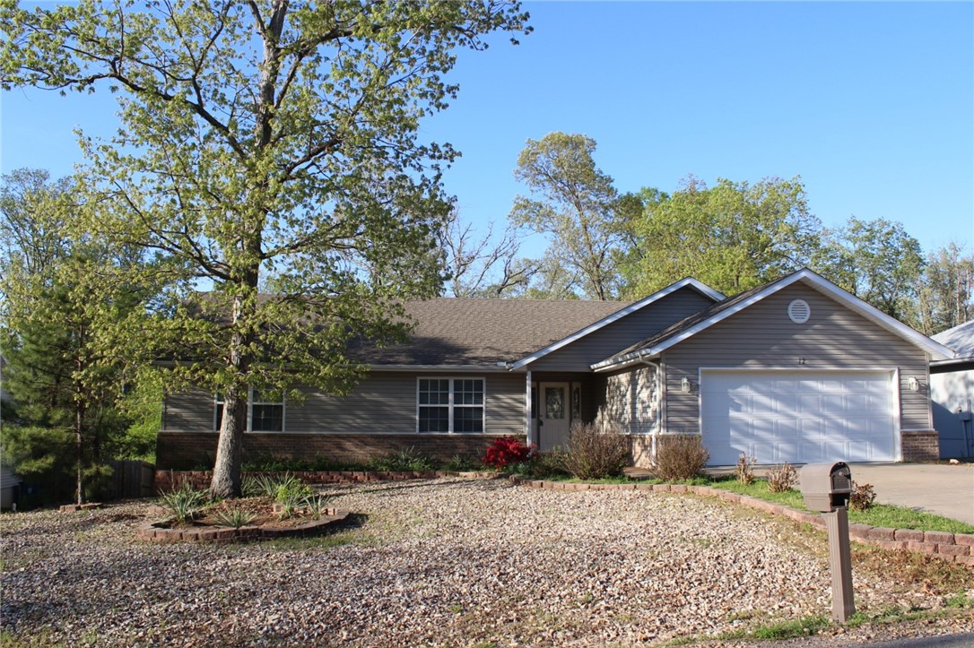 Updated and clean this home has 2 Bedrooms PLUS a 3rd room without a closet (could be an office or den) 2 bathrooms and a 2 car attached garage. Located on a cul de sac street, the LEVEL driveway is a a great feature also! New carpet, paint and vinyl plank flooring make this home crisp and ready to go! The Living Room features a propane log Fireplace and is open to the Dining Area. The Kitchen is a very functional "U" shape with LOTS of counter space, a breakfast bar and walk-in PANTRY. The 8' x 21' covered deck is freshly painted and a pleasurable spot to VIEW the woods. Refrigerator is included. 2 bedroom septic. Owner is a licensed real estate agent.