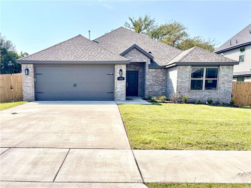 This newly constructed home, completed in July 2025, boasts exceptional craftsmanship and quality throughout. Offering 1,874 sq. ft. of living space, the home features 3 spacious bedrooms and 2 full bathrooms and fully fenced yard. The inviting living room includes a cozy fireplace and flows seamlessly into the dining area and kitchen, creating a perfect space for both relaxation and entertaining. The large dining area and kitchen island with counter seating provide ample space for hosting guests. The kitchen features sleek granite countertops, stainless steel appliances, and a convenient pantry. Smart home features, such as a Ring Doorbell and Google Nest Thermostat, add modern convenience. Large windows in the living area fill the home with natural light. The primary bathroom offers a luxurious experience with a fully tiled shower and a soaking tub. Each bedroom is equipped with generous walk-in closets, ensuring plenty of storage space. A 1-year builder’s warranty is included for peace of mind.