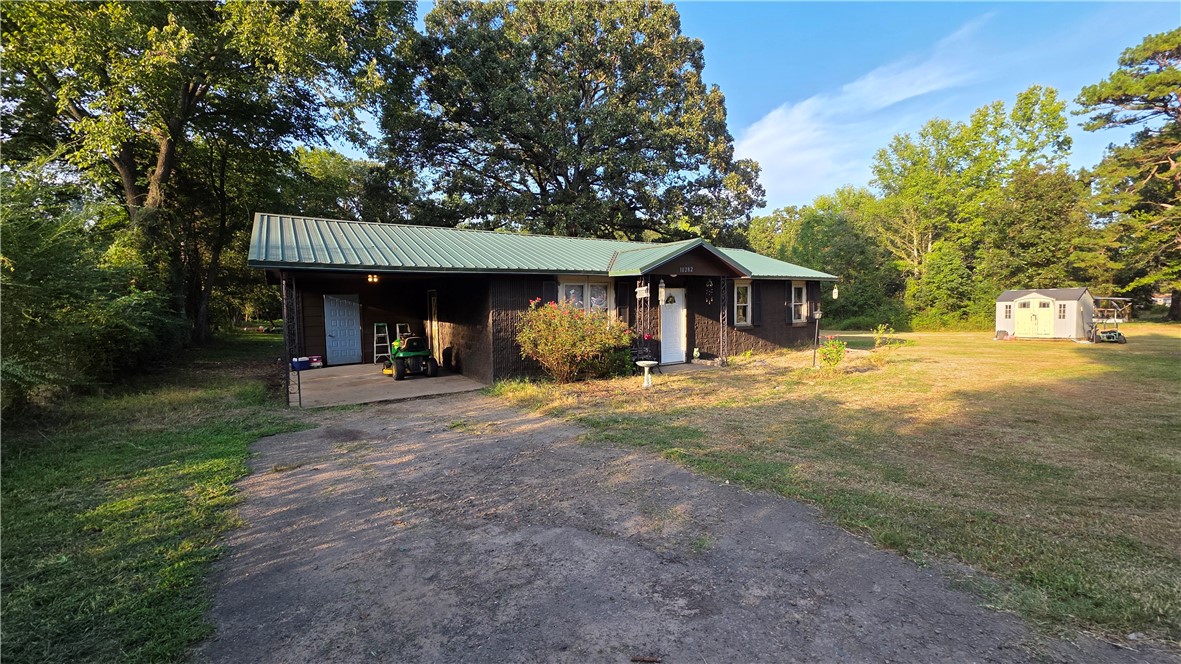 3 bedroom, 1 bath home on 2.5 acres. Enjoy a private walking trail and firepit in the woods behind the house. Features a dedicated laundry area with washer and dryer that convey. The large yard includes a storage building and ample space for outdoor activities. Bonus: John Deere riding lawn mower conveys. Open concept kitchen, dining, and living area. Refrigerator included. Roof installed in 2020, HVAC in 2021, water heater in 2019, and the septic system was new in 2019 and pumped in December 2024.