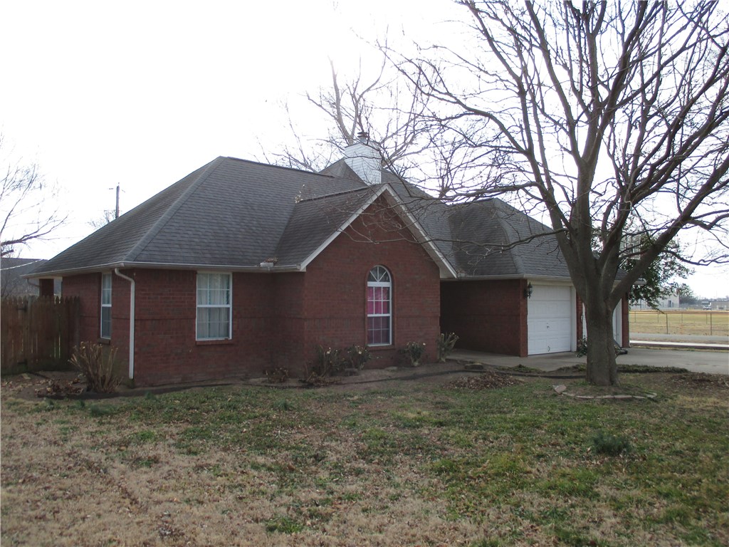 Nice three bedroom, 2 bath brick home in subdivision close to the Gentry high school and convenient to shopping and fire department! Good condition, ready to move in! Wood burning fireplace, harwood, tile & carpeted foors! Landscaping, storage building & back yard pricacy fence w/shade & guttering all on corner lot.