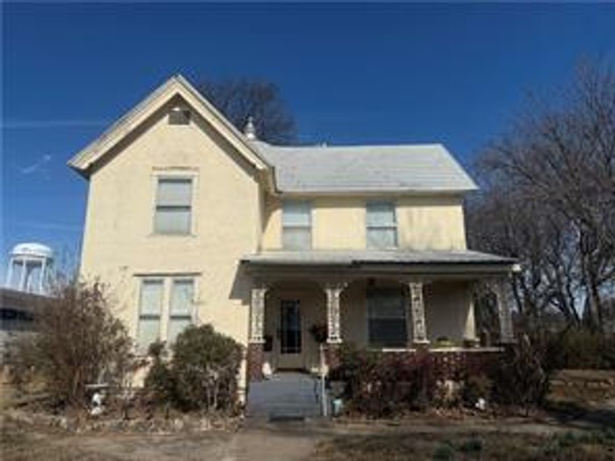 OUTSTANDING LOCATION! This stunning 2 story Victorian style home, with separate 2-level office space on 1.74 acres m/l is a must see! Situated on a high traffic street between two businesses, this property is prime spot for business, office space, bed and breakfast, rental property, or personal residence! Tucked away behind the trees, this beautiful 4-bed 2-bath home boasts an eat-in kitchen, laundry room, and fireplace. Spacious bedrooms allow plenty of room to stretch out and relax and a generous living room invites guests to stay and enjoy a peaceful respite from their daily activities. Outside, a large, screened back porch offers a quiet retreat overlooking the beautiful garden and fruit trees, a gazebo, and tranquil water feature. In addition to the main building, you will find a two-level office space with full bathroom, a large deck on the second floor, and a carport in back. This unique property offers flexibility, space, and location!