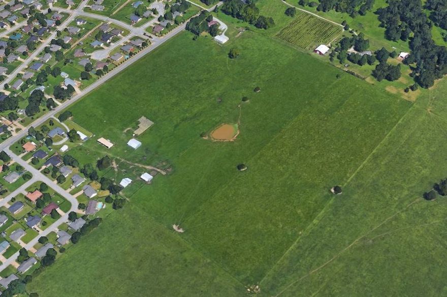 Excellent Development Opportunity! 37.59 Open, Level Acres in a great location along Honeysuckle Lane. Water runs to the front of the property along Honeysuckle. The closest sewer is at Nelda & Rogers Ave. just south of property. Buyer would need to verify sewer hookup. There is a house and outbuilding that is currently being rented on the south corner of the property. Survey has been completed.