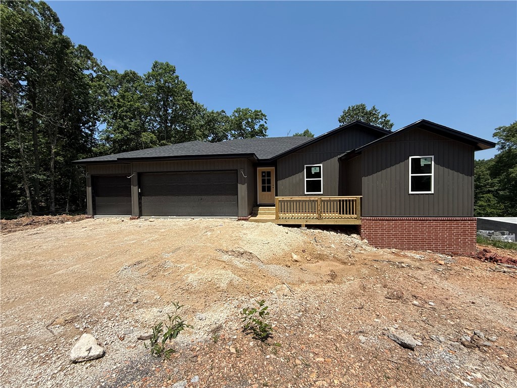Beautiful New Construction home in Bella Vista close to Loch Lomond. This stunner is a 2 bedroom with an extra room or office, 2.5 bath home and has storage galore. Abundant natural light in the spacious living room. Decorative fireplace framed by built in's and floating shelves. Gorgeous, open kitchen with a large island for entertaining. Split floor plan with a large master suite. Master bathroom with a free standing tub and custom tile shower. Large master walk-in closet that leads to the laundry room. Half bath close to the entry for guests. Custom cabinetry & woodwork with a mixture of Quartz and Granite countertops throughout the home. Beautiful modern light fixtures and cabinet hardware. Smart thermostat for energy efficiency. The exterior has a Ring Doorbell, custom cedar shutters, covered deck, & attached 3 car garage. Home will be completed in 45 days or less. Close proximity to Bike/Hiking Trails, Rec Centers, Golf Courses, and Lakes!!! 2 bedroom septic.