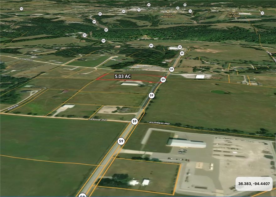 Level, Open 5.03 Acres with 328' highway frontage along Highway 59, 9000 VPD. The site is located in Benton County, one mile outside Gravette's downtown core. Parcel sits among dense commercial and industrial existing businesses.  Buyer to conduct own due diligence with Benton County on Conditional Use, Buyer to conduct own due diligence to verify utilities.