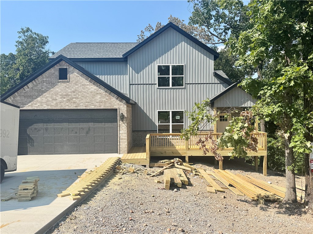 Gorgeous new construction home nestled in Bella Vista. Centrally located minutes from shopping, restaurants, and schools. Enjoy sitting on your covered deck enjoying this amazing lot, all the mature trees and privacy. Great home with fantastic layout, tray ceilings throughout and large rooms. Secondary bedroom on the main level. Large living room with beautiful gas fireplace, open floorplan LVP flooring on the main level and views of the mature trees. Kitchen has custom wood beam with vaulted ceiling, granite countertops, stainless steel appliances, large eat-in kitchen area and pantry. Large master bedroom with LVP flooring and spa like master bathroom has double sinks, soaking tub, walk-in tile shower with bench and large walk-in closet. Secondary bedroom on the second floor, large bedroom upstairs with extra storage and large bonus room for all your needs! Relax on the covered deck with stairs down to the backyard overlooking the backyard and views of the mature trees.