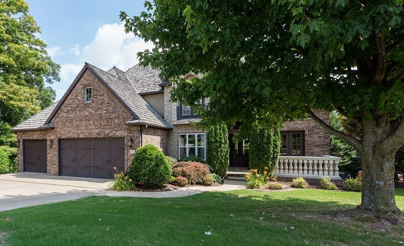 Pinnacle Country Club living with beautiful views of the 5th green and tee box. Enjoy 5,265 heated sq ft with 5 bedrooms and 4.5 bathrooms, oversized eat in kitchen, formal dining, study, great room w/ incredible views, theater room, wet bar, bonus, separate laundry, and second living. Amenities include gorgeous hardwood floors, vaulted ceilings, custom cabinetry, all wet bar and kitchen appliances convey, tons of storage, double crown molding, beautiful outdoor living space w/ a fire pit and koi pond, and a 3 car garage. Basement has a heated and cooled room w/ French doors to accommodate a golf cart. Community pool and tennis court. Zoned for Bentonville schools.