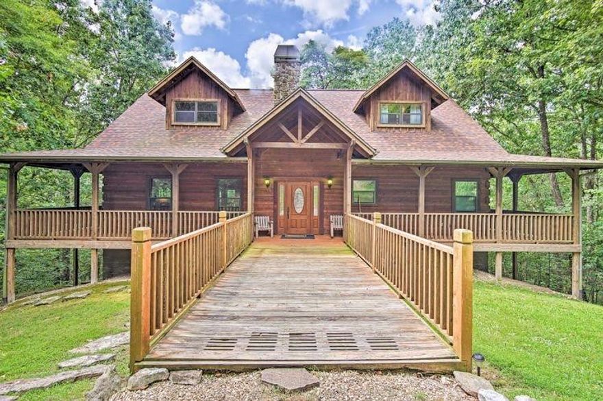 This 3340 square foot 3 story 4 bedroom 3.5 bathroom home comes FULLY FURNISHED (including pool table and video game arcade console) in a unique gated cabin development in NW Arkansas. This Satterwhite built home's interior is designed with full cedar logs and Engelman spruce knotty pine walls throughout. A steady stream bubbles out back as you're surrounded by tall trees providing a peaceful setting and comfort while relaxing on either one of the two wrap around porches. Take advantage of the fishing and hiking nearby too! This home is currently on an VRBO listing providing additional income. Two new HVAC units installed in 2024.