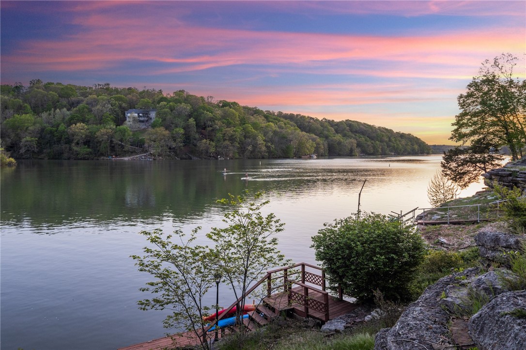 The most organically beautiful property on Lake Ann with views for days can be yours before summer! Lake Ann is a wake lake perfect for recreation and relaxation! This property has a private boat dock and is walkable/bikeable to the Back 40 Mountain Bike Trailhead and boat launch. This well-maintained, thoughtfully upgraded home offers 3 large bedrooms with full ensuite bathrooms which is a rare find! Walk into upper-level primary living area with guest bathroom, formal dining room, large laundry room with drop zone, two bedrooms with full ensuite baths and oversized heated and cooled sun room. Lower level can be accessed from inside the home or can be used as a private quarter accessible from the exterior of the home. Lower level offers private living quarters with additional living room, kitchen, laundry, one bedroom and full ensuite bath. Upgrades: Oak and Pergo flooring, roof, skylights, septic pump, fixtures, fridge, washer, dryer, microwave, insulated garage door and extended patio. Don’t miss this one!