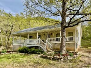 This cottage is a get-away tucked in the trees---the 13.23 acres feature a seasonal creek AND a year-round creek! You can hike the trails or float the nearby river and creeks. Ranchette Access to the White River=12 min away. Cedar Creek Access to the Buffalo Nat River= 30 min, boat launch at Dillard's Ferry=40 min. Seller has remodeled, completely painted the interior, added crown molding, etc. The internet/TV service is provided by Starlink and system is available to purchase separately. The shower and entry doors are handicap accessible and the driveway takes you to the back of the house for easy entrance at ground level. Think of this house as a cozy cottage, an AirBNB, or a weekend get-away from the hustle and bustle of the work week. That front porch is waiting for you!