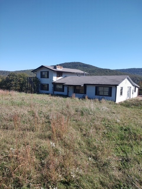 Large two story home with over 2,700 sq ft. Two bedrooms upstairs and two bedrooms downstairs. Pantry and laundry room. Fireplace in living room. Separate dining area. Large master bath. 1.56 acres +/- with terrific views.