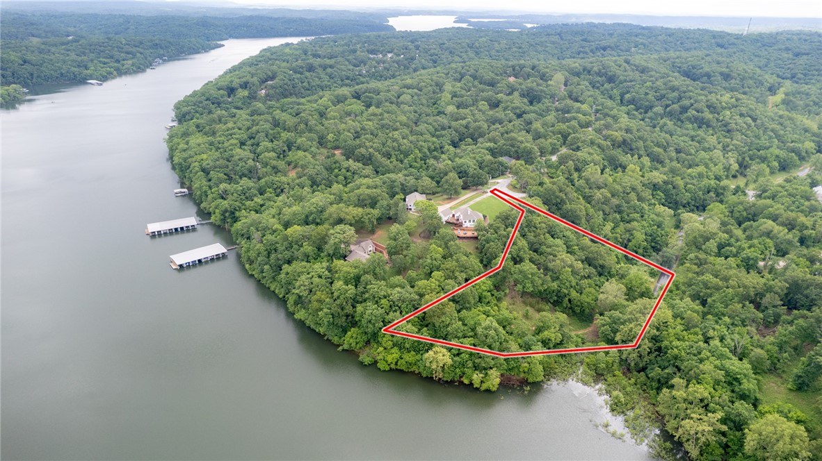 Mountain Lake Estates Lot w/Boat Slip! This 2 Acre Lot has wooded setting and easy access to Beaver Lake Including a boat slip in the community dock. The property is a perfect setting for your lake home build with electric/gas/water at street. Located in sought after Lake Community just a short drive to Downtown Rogers shopping, dining, and entertaining. Don’t miss out on this fantastic lakefront opportunity!