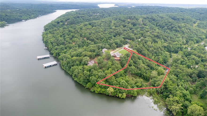 Mountain Lake Estates Lot w/Boat Slip! This 2 Acre Lot has wooded setting and easy access to Beaver Lake Including a boat slip in the community dock. The property is a perfect setting for your lake home build with electric/gas/water at street. Located in sought after Lake Community just a short drive to Downtown Rogers shopping, dining, and entertaining.  Don’t miss out on this fantastic lakefront opportunity!