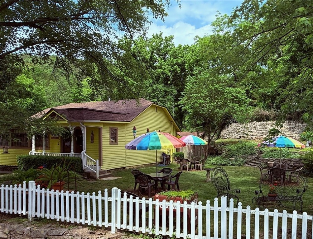 A favorite of Eureka Springs’ tourists for decades, Ice Cream Delights takes folks back to their youth when ice cream parlors and soda fountains could be found in every small town. The interior has black and white flooring, classic ice cream parlor tables and chairs and Coca-Cola memorabilia. The owners have operated the business for 35 years serving ice cream, milk shakes, sundaes, fountain drinks, cobblers, sandwiches and hamburgers. A large side yard provides outdoor seating at tables with colorful umbrellas. Furnishings, equipment and memorabilia conveys. Currently open for lunch, six months out of the year, but new owners could extend the months and hours. There are two outbuildings: a 266 sq. ft. guest cottage that the owners use when working and a 337 sq. ft. garage with a workshop and storage. Well-maintained building with a new architectural shingle roof. Excellent corner location on Main Street with high visibility, fantastic curb appeal and off-street parking.
