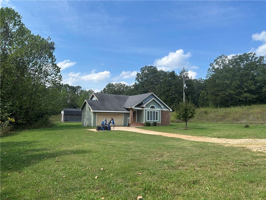 Don't miss this opportunity to own a 5 acre parcel close to town on a paved road.  Less than 3 miles to Hwy 16.  The home was custom built and has had just one owner.  Some TLC is needed such as paint, trim work and a new garage door.  Well worth the investment to have this tranquil country setting which would make a great hobby farm.  Plenty of room for some livestock, chicken coops etc. A wet weather creek flows across the property.  There is carpet in just 2 bedrooms - elsewhere the tile and laminate are in very good condition. The kitchen cabinets are custom hand made.  The fireplace in the living room uses propane. Large linen closet plus nice storage shelving in the main bathroom. There is plenty of storage throughout the house and garage.  Patio doors open from the 1st bedroom to a spacious deck - a lovely spot to watch the wildlife.  There is a 20' x 12' storage building.  Lots of potential here to spread out and add your personal touches.  To be sold as is.