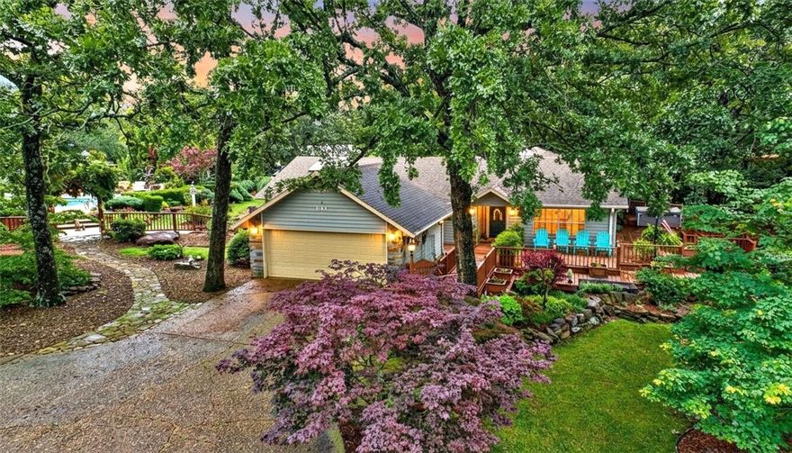 This well-appointed Fayetteville home offers privacy, comfort, and convenience on over an acre just minutes from amenities. The 3,357 sq ft residence features three bedrooms, three and a half baths, updated hardwood floors throughout, a newer HVAC system, whole house generator, and a two-car garage.
Highlights include a wrap-around porch, professional landscaping, sunroom with skylights, and a fireplace in the main living area. The kitchen boasts granite counters, stainless appliances, custom cabinets, and a breakfast bar adjacent to a formal dining room. The main floor master suite provides hardwood floors, ample closet space, and a bath with dual vanities, soaker tub, and walk-in shower. Two additional bedrooms are suitable for guests or flexible use. Outdoor amenities feature a self-cleaning sport pool, hot tub, large patio, pergola with lighting, greenhouse, lush yard, and private guest house with its own bedroom, bathroom, kitchen, and living area. Appliances and pool equipment are included.