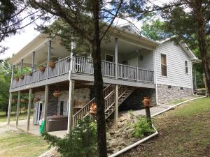 Unbelievable views from this custom 3 BR 2BA home overlooking Bull Shoals Lake. This home has a virtually maintenance free exterior with the rock, Polymer siding, and Trex decking. The interior has solid Oak flooring and tile throughout, vaulted wood ceiling and cedar lined closets. The 40 x 40 shop has 6'' poured floor, insulated with 220 wiring. The storage building and greenhouse also have electric and water. You need to see this one! So much value for the money.
