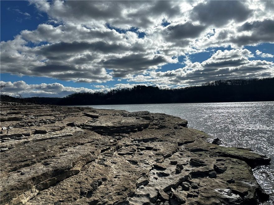 Very buildable lot with fantastic lake view and low Corp line.  Just surveyed in Feb. 2026 at .93 acres, this is a perfect place for a secluded cabin with outstanding views and very easy "lake approach". Drive past the Hidden Diversity Piney Trailhead through the heart of beautiful Hobbs State Park to get here. Your power runs across near the bottom of the property. If you have been searching for an inspiringly beautiful and remote part of the Ozarks, this should be on your list.  GPS-Lot is across from 14532 Horseshoe Lane.