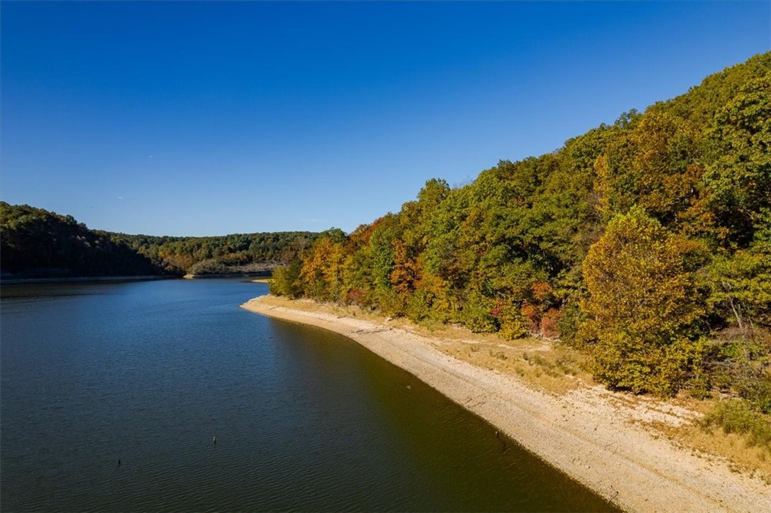 Looking for lakefront, beautiful views and privacy? This property has over 3200 ft of lakefront w/2 access points. One at the end of Hickory Springs on the north, one at the end of Natural Walk on the south. Deeded easement from the end of Hickory Springs to the parcel. There is already a path through the property leading to a clearing, which can be accessed by parking at the end of Hickory Springs Rd and walking. Property can also be accessed and waterfront viewed by approaching from Natural Walk. Highway 412 East, left on W. Hickory Flat/97, straight onto Natural Walk.