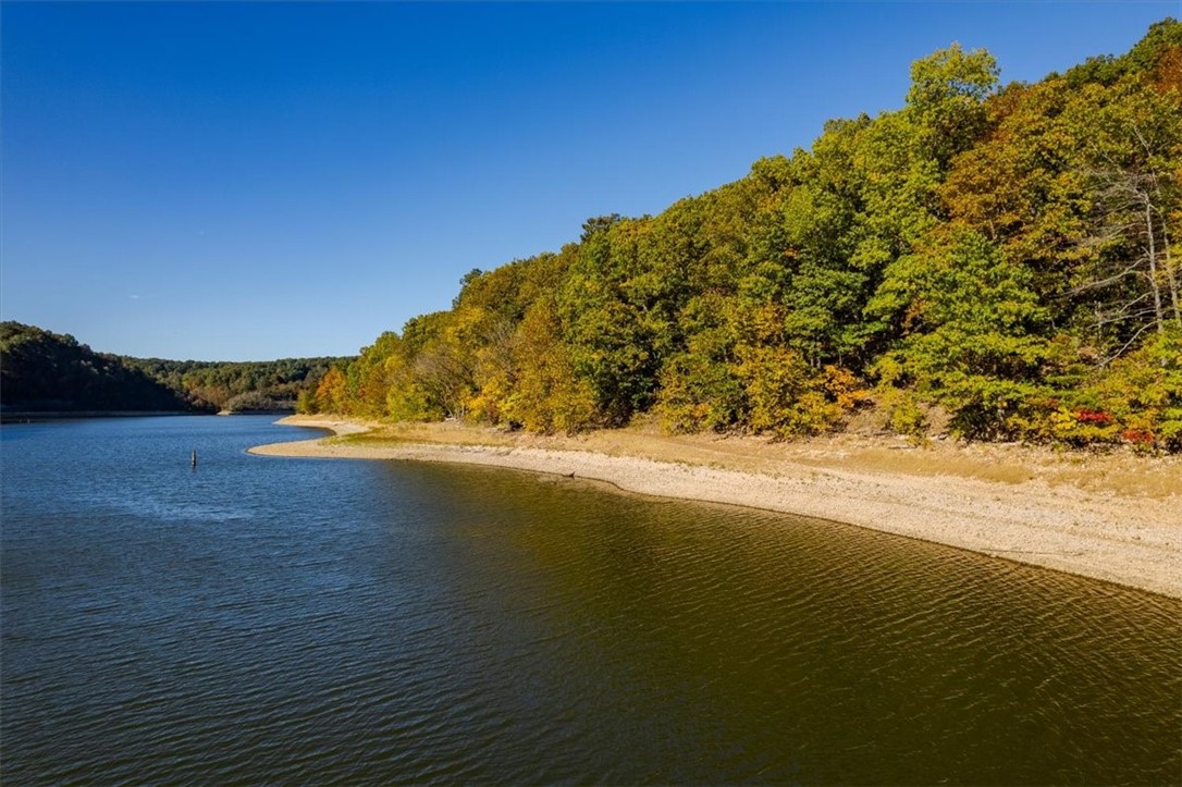Looking for lakefront, beautiful views and privacy? This property has over 3200 ft of lakefront w/2 access points. One at the end of Hickory Springs on the north, one at the end of Natural Walk on the south. Deeded easement from the end of Hickory Springs to the parcel. There is already a path through the property leading to a clearing, which can be accessed by parking at the end of Hickory Springs Rd and walking. Property can also be accessed and waterfront viewed by approaching from Natural Walk. Highway 412 East, left on W. Hickory Flat/97, straight onto Natural Walk.