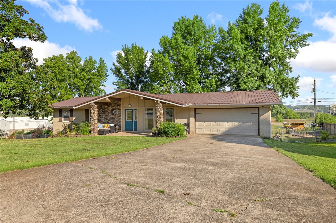 This spacious home offers over 3,000 sq ft with 4 bedrooms, 2 bonus rooms, and 3 full bathrooms, plenty of space for everyone. The walk-out basement features a huge family room perfect for gatherings, movie nights, or a game room. Upstairs, you’ll find bright living spaces, a sunroom for enjoying natural light year-round, and a functional kitchen with plenty of storage. Outside, the large fenced backyard provides privacy and room for pets or play. The property backs up to the Harrison School District campus, placing the middle school, high school, and football stadium just steps away, a great location for students and Friday night lights fans. Don't miss the tool shed under the sunroom! Recent updates include a new HVAC system (2023) and a brand new metal roof (2025). This move-in-ready home in the desirable Skyline Terrace neighborhood combines space, convenience, and value in one package.
