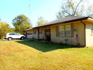 Looking for your piece of the country. Come see this charming ranch-style home with almost an acre of cleared land to roam. This brick home is 1,600 square feet encasing 3 bedrooms, 2 baths and a 2-car garage with plenty of room to grow. Cozy up next to the wood burning fireplace at night or have your coffee on the covered porch; there is something for everyone at this home including a 3-stall storage barn. Currently home is an investment rental and you too could use it as such for added income. Call today for your private tour and make this your next home or investment.