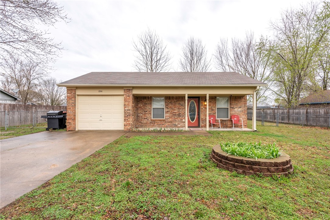 WELCOME HOME! This 3 bedroom 1 bathroom home is located minutes away from shopping, eateries, schools and parks in Elkins while being less than 15 minutes to Fayetteville! New Hot Water Heater in 2023! From the covered front porch head inside to the living room with wood flooring with a semi-open concept opening to the dining room and kitchen with lots of cabinet space and stainless steel appliances! 3 Bedrooms and full bathroom with double sink vanity! Out back enjoy a fenced in yard and 12x12 storage shed!