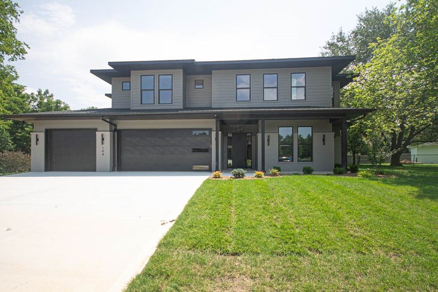 Located in the perfect location w/ easy access to Coler Mountain Bike Preserve trails, schools, downtown Bentonville & more. Spacious living room basks in natural light streaming through expansive windows, complemented by a cozy gas fireplace. Kitchen is a culinary haven, boasting two-tone cabinets, quartz countertops, pot filler, extensive accent lighting, veggie prep sink, high-end Cafe appliances including remarkable six-burner range with griddle, double ovens & hidden working pantry. Elegant dining room with custom drop-down wood ceiling & dry bar. Luxurious primary suite with captivating wood accents in sitting area & master bath & spa-like bathroom featuring double sinks, designer touches, smart mirrors, soaking tub & fully tiled walk-in shower with rain head. Additional highlights-main-level study and secondary bedroom. Upstairs bonus room with wet bar perfect for entertaining. Sprawling outdoor covered patio perfect for outdoor gatherings. Bike storage and washing station perfect for the outdoor enthusiast!