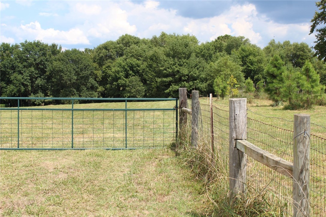 Beautiful setting for your new home. This 4.45ac tract has a pond with a small fishing dock. Room for a horse or two. Gentle slope would allow for a walk-out basement. Property is fully fenced with a gate at the driveway. Water tap has been paid and water hydrant is on site for watering your garden. Percolation test done previously, but would need new one. The old soil analysis report is available and shows good results. Many pine trees have been planted around perimeter.