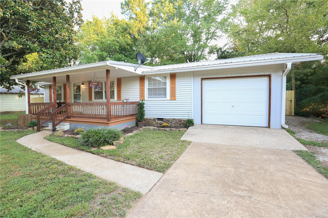 This delightful Huntsville home is a rare find for those seeking the ease and charm of small-town living. Step inside to discover beautiful pine hardwood floors and a spacious living room that flows into the dining area and kitchen, while the split floor plan provides privacy for the primary suite. Throughout the home youāll find cordless faux wood blinds, custom cedar closets and updates including a new garbage disposal (2025). Kitchen appliances, washer, and dryer convey with an acceptable offer! Enjoy the outdoors in the fully fenced backyard with a brand-new fence. A Lily Magnolia blooms twice a year with stunning purple flowers, complemented by mature Magnolia trees in the front and back. The large covered front deck is the ideal spot for morning coffee or evening relaxation. Located in a quiet neighborhood within walking distance to downtown, schools, and parks, this home combines small-town charm with unbeatable value. Donāt miss your chanceāhomes this clean and this cute at this price point in NWA are rare!