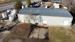 Excellent building located minutes off of interstate 40 in between Russellville and Dover along Hwy 7N. With over 9,000 sq ft situated on over 2 acres of land that is all fenced. The building features 2 loading docks and one additional overhead garage door at ground level. Inside features office areas downstairs and upstairs. Environmental reports on file are available upon request.