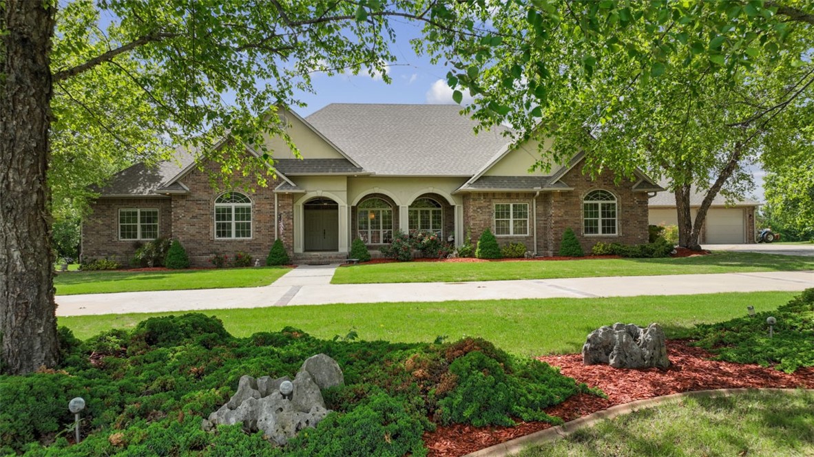 First time on market! This stunning 4329 SF custom home sits on 3.39 meticulously landscaped acres backing to creek. Step outside to enjoy your Yoder greenhouse w/electric, covered patios, pergola, gazebo, pumphouse w/storage & additional 1/2 bath, sprawling gardens of established berries/vegetables and surround sound (inside & out). The heart of the home is a chef's dream w/double oven, gas stove & warming drawer and the well designed central gathering island & kitchenette hearth room create the perfect atmosphere for shared meals & memories. Luxurious master retreat w/marble jacuzzi & unique multi-season closet. So many special details including instant hot water, new roof (2022), central vac, abundant storage, bunker/tornado room, hot tub room, multiple workshops, XL bonus/activity room, 10-14ft ceilings, recessed lights, glazed cabinetry, large crown, picture nooks, zoning for barns/horses & more. Enviable property only minutes from historic Main Street. Most furnishings negotiable. Make this home your own!