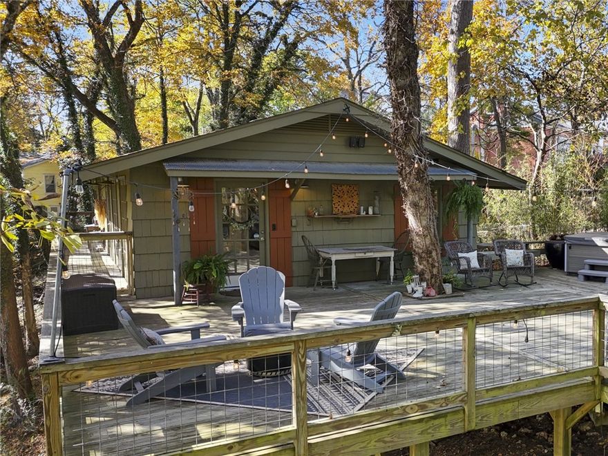 An expansive front deck surrounded by trees sets the tone for this completely remodeled 3 BR/2.5 BA cottage that feels like you are in the woods instead of the Historic District. A French door opens into a foyer featuring an art wall flanked by openings to the dining area. A gourmet kitchen with an island features butcher-block counters, custom cabinetry, and built-ins. The living room has three walls of windows that make it feel like a treehouse, with a cozy gas-log fireplace. The main-floor ensuite bedroom is spacious, and the bathroom features a walk-in shower and a vanity with two glass bowl sinks. A powder room completes the main floor. The lower level has a sitting area, two bedrooms, and a full bath. There’s also a laundry room, a bonus room that could be an office or storage. The carport also has a storage room, and there’s space for two more cars in the driveway. You’ll enjoy the Crescent Park neighborhood with a concrete walking trail providing a shortcut to your favorite downtown shopping and dining.
