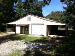 What Potential! 1200 sqft ,semi-finished, metal building with over 1100 sqft of carport/overhang area, two other outbuildings, over 4.5 acres, on pavement, just out of Harrison city limits.