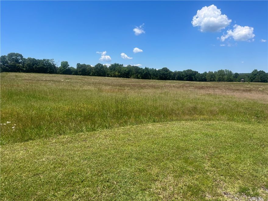 Enjoy the peace of country living while still being conveniently close to town amenities with these 8 +/- acres just outside the city limits.  This beautiful property offers highway frontage, a picturesque setting and endless potential with plenty of space to build your dream home.