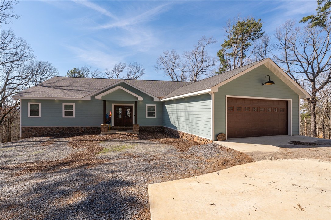 Modern Mountain Harbor retreat with room for everyone- Custom-built in 2022 by Lawrence Custom Builders and packed with luxe finishes, effortless style, and lake gateway vibes. This 4-bedroom, 4.5 bath home is a rare gem in the covered Harbor South neighborhood, offering a thoughtful layout with three spacious primary suites- two of which are conveniently located on the main level. With accommodations for up to 22 guests, there's no shortage of space for hosting family, friends, or vacationing in style. Step inside to soaring wood-paneled ceilings, warm hardwood floors, and a dramatic open-concept living space that flows seamlessly from the chef's kitchen to the cozy living area- complete with a sleek electric fireplace and wall of windows that frame the surroundings trees. Quartz countertops, custom cabinetry, designer lighting, and a built-in wet bar add just the right touch of elegance. Fully furnished, minus a few sentimental pieces, this home is move-in ready.