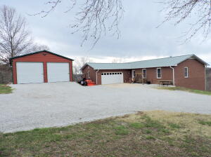 Spacious 6 bedroom, 3 bath brick home on 18 1/2 acres near Bull Shoals Lake, Table Rock Lake, Branson, Missouri and Harrison, Ar! Many updates in this home including a 2 year old metal roof, newer sun room, quartz countertops, windows and doors, flooring, garage door and opener, whole house backup generator, and much more. Rec room and large storage room in basement. Attached double garage plus a 20'x25' metal garage/shop. Gorgeous view. Pasture. Woods. Hardwood and pine. Only 2 miles to school and town.