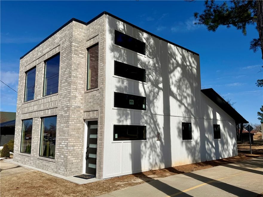 Run your business from home with this rare mixed-use opportunity at the corner of Promenade Blvd and the Razorback Greenway Trail. Newly remodeled 1,616 SF home features 3 bedrooms, 2.5 baths, and a privacy-fenced backyard. Two modern 600 SF commercial office spaces overlook the high-visibility corner. Situated on 1.05 acres, the property offers room for additional parking or a third structure. Just minutes from Promenade Mall, Restaurant Row, Whole Foods, and the I-49 Walnut exit. High-traffic location with 40,000+ vehicles per day makes this ideal for live/work, professional office, or boutique retail use.