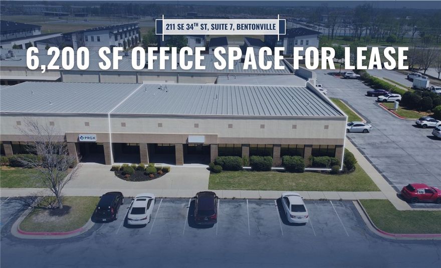 Suite 7, offers a functional layout ideal for a variety of office users. The space includes six private offices, a large breakroom, a conference room, and several open coworking areas, providing a balanced mix of collaborative and focused work environments. Restrooms will be added by the landlord. A dock leveler is on site with level sidewalk access into the space, offering added convenience for users.

Ideally positioned less than a 2-mile drive from Walmart and Sam’s Club Home Offices and less than 2 miles from Interstate 49, the property provides excellent accessibility with convenient access to S Walton Boulevard and quick connectivity to downtown Bentonville and Pinnacle Hills. Numerous windows provide abundant natural light throughout. This property is particularly well-suited for Walmart vendors seeking a strategic location with manageable rental rates.