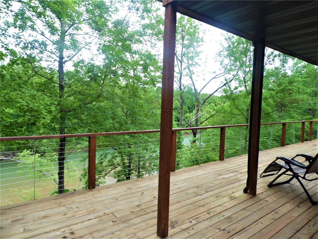 Unusual, contemporary home peers right out over Kings River! Featured in Dwell Magazine, as well as on HGTV for example of how an ultra modern, contemporary home can feel right at home in the Ozarks. All emphasis is on clean lines, natural light streaming in from windows both high and low, and the stunning and ever changing views of the wild, natural Kings River just below. Seller says is like living in a tree house! Selling with beautifully minimalist furnishings, but could easily adapt to your taste.