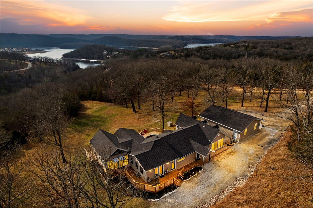 Welcome to your lakeside escape! Situated on 10 acres of land with a stunning lake view, this magnificent property offers the perfect blend of tranquility and entertainment.
Currently an active short-term rental, this property comes fully furnished, offering a turnkey opportunity for any home owner, investors, or those seeking a vacation home that pays for itself!
With 4 bedrooms and 4 baths, there is ample space for family and guests to unwind.
Enjoy evenings gathered around the fire pit, pool, hot tub, and deck, sharing stories and making memories under the stars!
The large detached game room provides endless entertainment possibilities, perfect for hosting game nights or enjoying indoor recreation away from the main house.
Conveniently located near Branson Airport, multiple golf courses, and dining options at Top of the Rock, this home offers easy access to all the amenities and attractions the Branson area has to offer.
Don't miss your chance to experience this ultimate lakefront lifestyle!