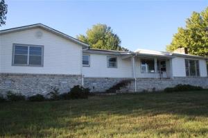 Brick & vinyl exterior with covered patio. One car attached garage, with oversized one car detached garage. 3 bedrooms, 2 bath, large living room with wood burning stove.