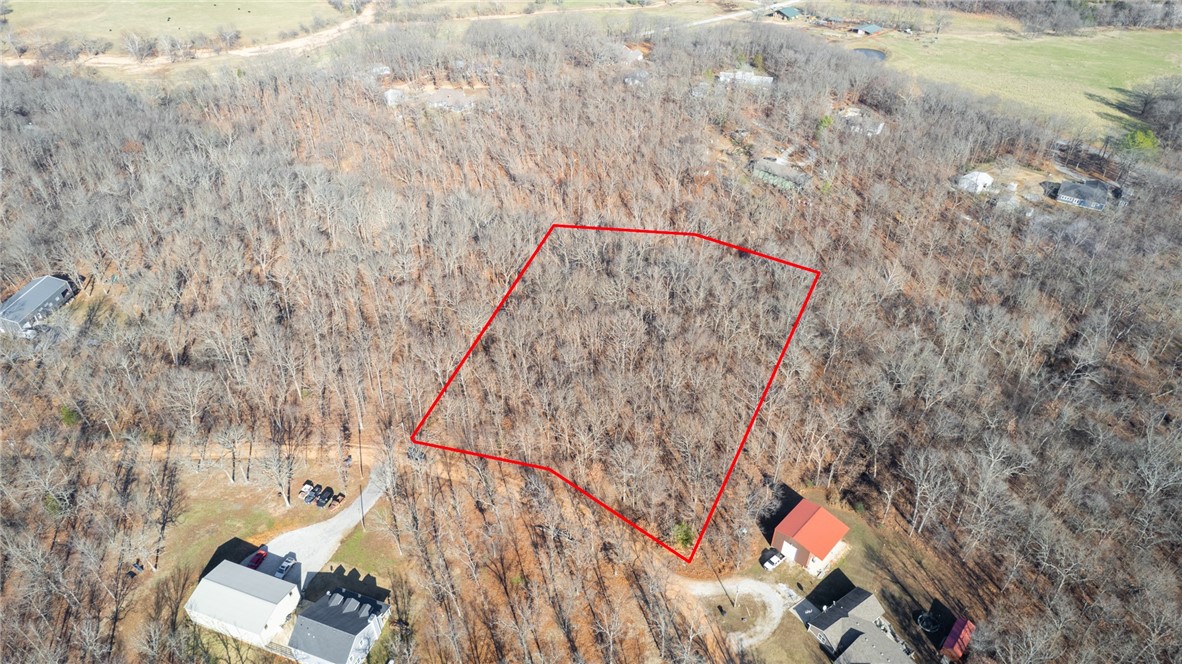 Discover the rare opportunity to own this beautiful 3.5-acre wooded retreat, nestled in the heart of Gravette, AR. Electric and city water are available at the road, making it easier to bring your dream home or getaway cabin to life. This one-of-a-kind property is a nature loverās dream, featuring mature oak, hickory, and cherry trees, along with blooming dogwoods, redbuds, and maples that create a stunning palette of colors each spring.
Wildlife thrives on this property, with deer, foxes, and squirrels as regular visitors. Complementing the peaceful atmosphere, a wet-weather creek winds through the back during rainy seasons, enhancing the property's natural beauty and tranquil charm.
The recently paved road leading to the property ensures convenient access, with only a short stretch of gravel to your future driveway. Multiple potential building sites offer flexibility, whether you prefer to build closer to the front or tucked away in the peaceful back of the property.
Stop by to take a look today!