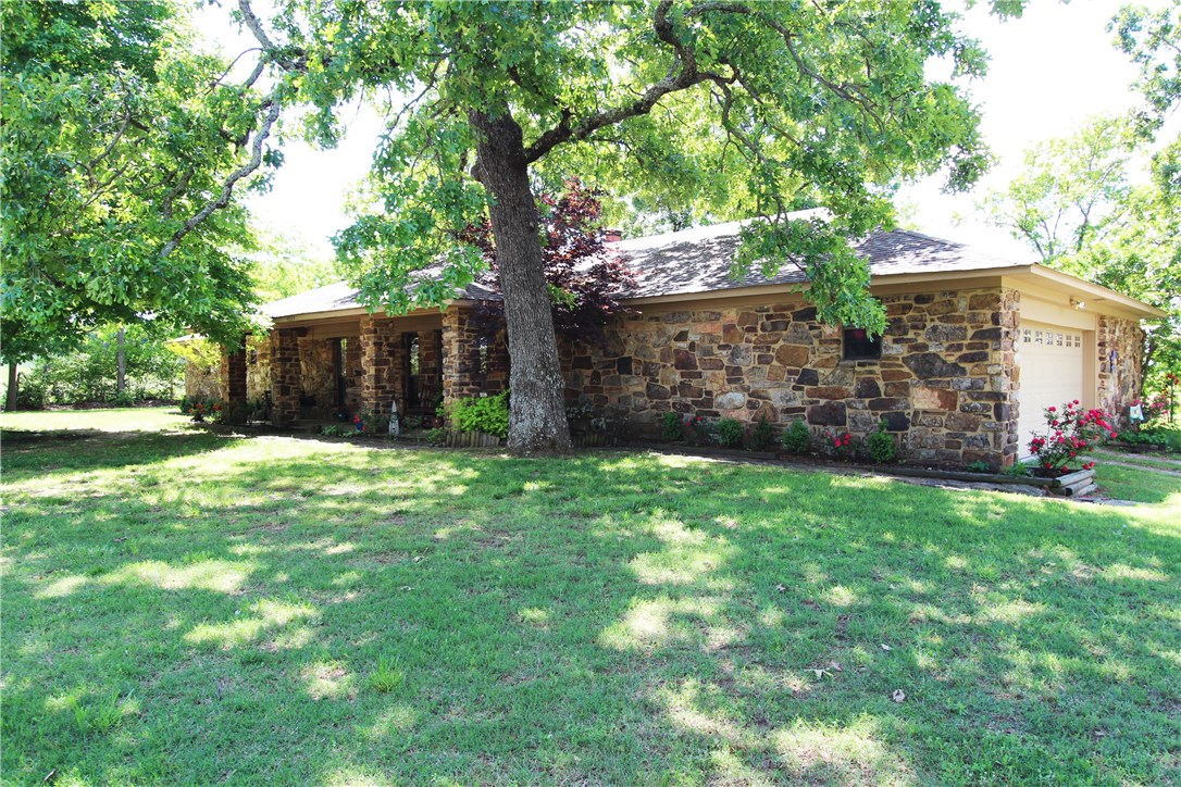 If you want to live on the outskirts of Alma on a tree scattered 1.34 acre lot in a rock home with extensive kitchen and bath remodeling already done. This is your new home! Kitchen is brand new w/ 3cm granite, under-mount lighting, new cabinets, farmhouse sink and stainless appliances. Wood tile flooring in kitchen, dining and laundry. hall bath and laundry rooms also brand new. Huge (26x19) living room w/ cedar accent wall & wood burning FP. 32x22 detached building. Covered Front porch.