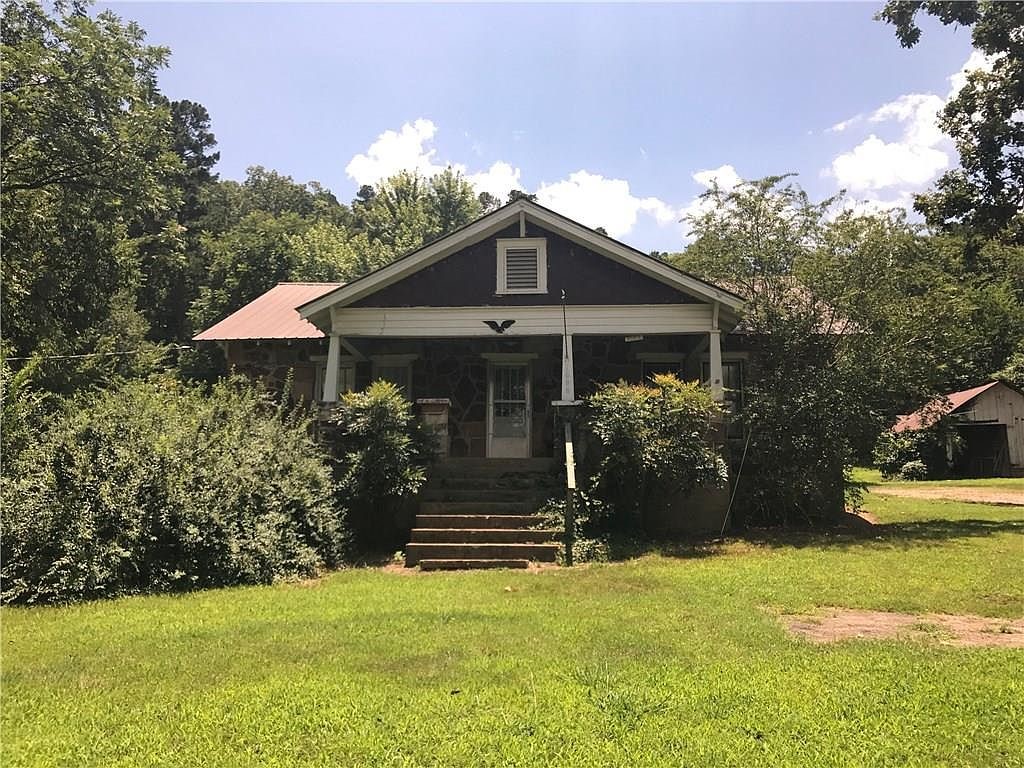 Peaceful 2-Acre Homestead – Endless Possibilities!
Looking for a quiet, self-sufficient lifestyle? This charming 2-acre homesteading property offers just that! Featuring 3 greenhouses (one heated), a sturdy metal shop (20x25) for all your tools, and producing pear trees and muscadines, it's perfect for anyone wanting to live closer to the land.
The rock home is a blank canvas ready for your personal touch. With an open floor plan, it includes 2 bedrooms, a bonus room off the second bedroom (great for an office, nursery, or studio), and 1 full bath. Home also has a dirt cellar! There is also a well to keep those green houses and flower beds watered! Home is being SOLD AS IS.