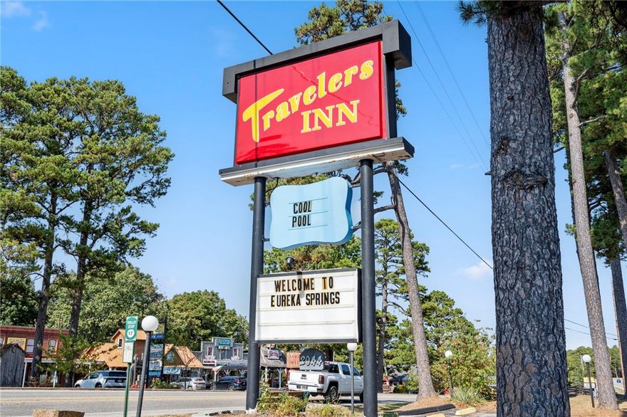 SELLER FINANCING OFFERED – 6.75% interest, 3-year term, 50% down for qualified buyers/operators. This charming 56-room motel in the heart of Eureka Springs sits on +/- 9.7 wooded acres and presents a strong investment opportunity. Over $225K in recent upgrades include new flooring, paint in 44 rooms, bedding, towels, laundry appliances, water heater, and pool plaster. Guest rooms offer private baths, flat-screen TVs, plush beds, and pet-friendly options. Room types include standard kings, single/double queens, and queen suites across four two-story buildings. Amenities include an outdoor pool, sundeck, picnic areas, BBQ grills, and a cozy outdoor fireplace. A renovated 3-bed, 2-bath Airbnb near the entrance (with $14K in updates) provides added income or employee housing. Located just 6 minutes from Downtown and on the Trolley’s Blue Route (Stop #17) for convenient guest access.