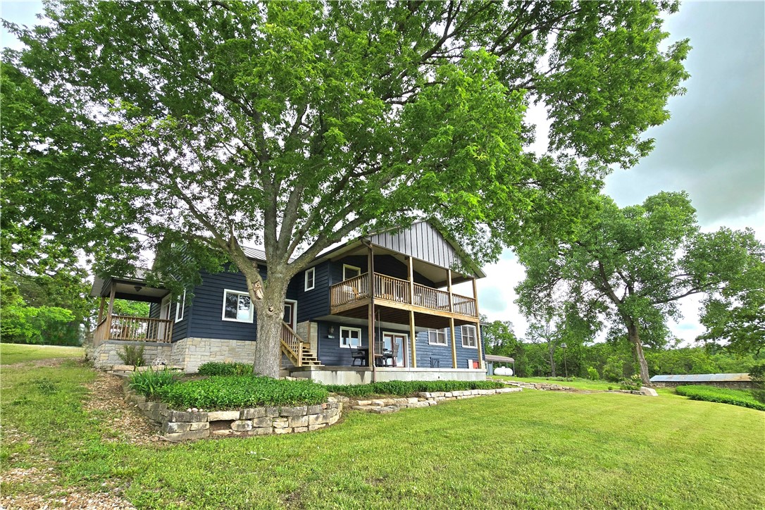 The views are spectacular from this custom-built home on 6+ acres with Kings River frontage! You will find a warm and inviting, split level, home that is full of beautiful finishes throughout including hardwood floors and cedar plank ceilings. The kitchen boasts of custom cabinetry, granite countertops, a massive pantry, stained concrete flooring with radiant heating, along with all the appliances. Your oasis awaits just off the primary bedroom. There, you will find a private balcony overlooking the river and countryside to watch the sun set. At the end of the hallway, you will find a flex space with a half bath and separate entrance that could be used for a home office, game room, additional bedroom, or more. Other amenities include walk in closets in all bedrooms, central vacuum, tiled walk-in showers, jetted tub in primary, 85-gallon water heater, and laundry sink. Fenced on 3 sides. Multiple outbuildings for livestock and storage for your kayaks, canoes, and fishing gear! Make this your home! Call today!
